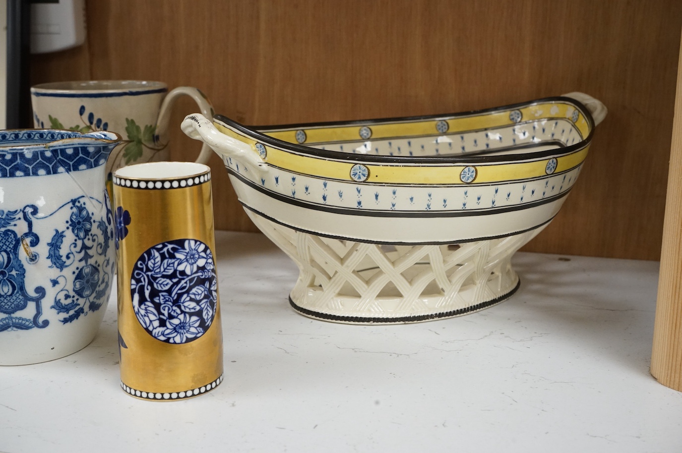 A George III creamware basket, a pearlware mug and jug, a Coalport spill vase (four), basket 26.5cm handle to handle.